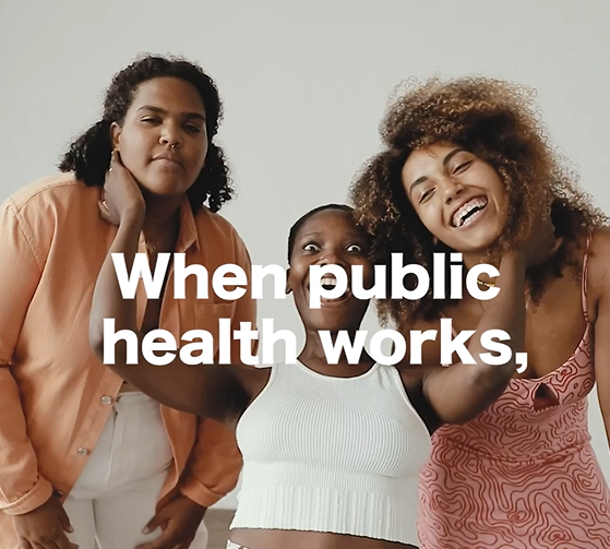 Graphic includes three Black women who are laughing together. Text says "When public health works"
