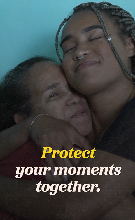 A Black Latina girl hugs her Latina grandmother