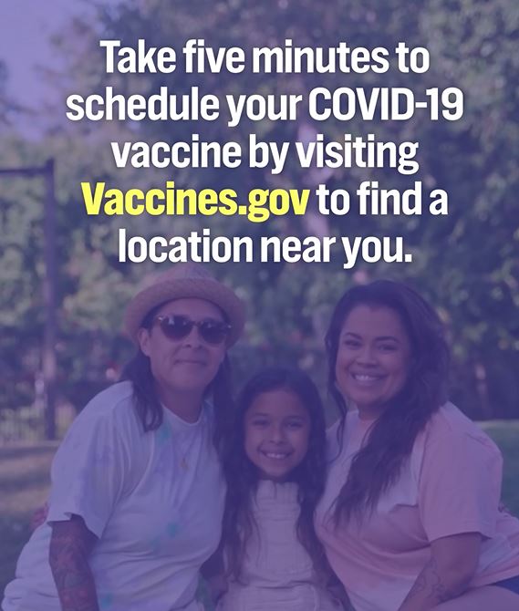 Image of two adults smiling with a young girl.