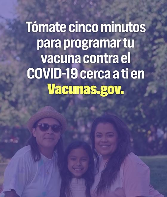 Image of two adults smiling with a young girl.