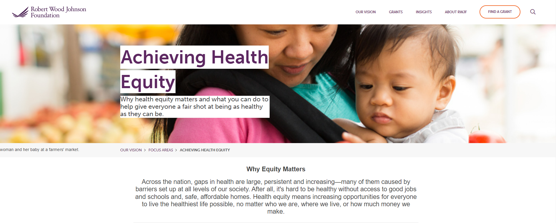 An Asian woman with her baby at the farmers market 