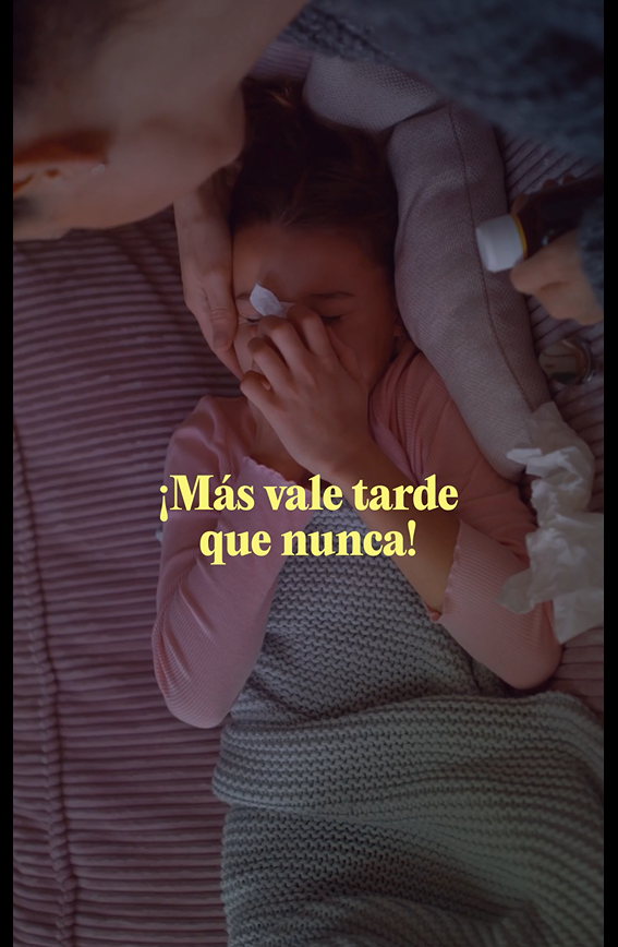 Image of a white girl blowing her nose and her mother caring for her.