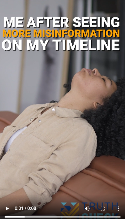A young Black woman sits on a chair and leans her head back. 