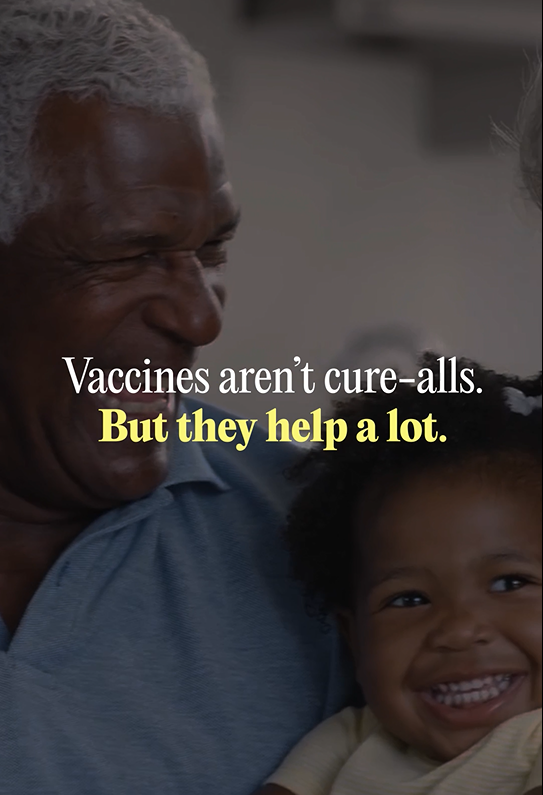 Image of a Black family gathering including a grandfather and granddaughter smiling