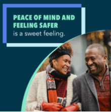 A black man and woman smiling at each other while on a walk