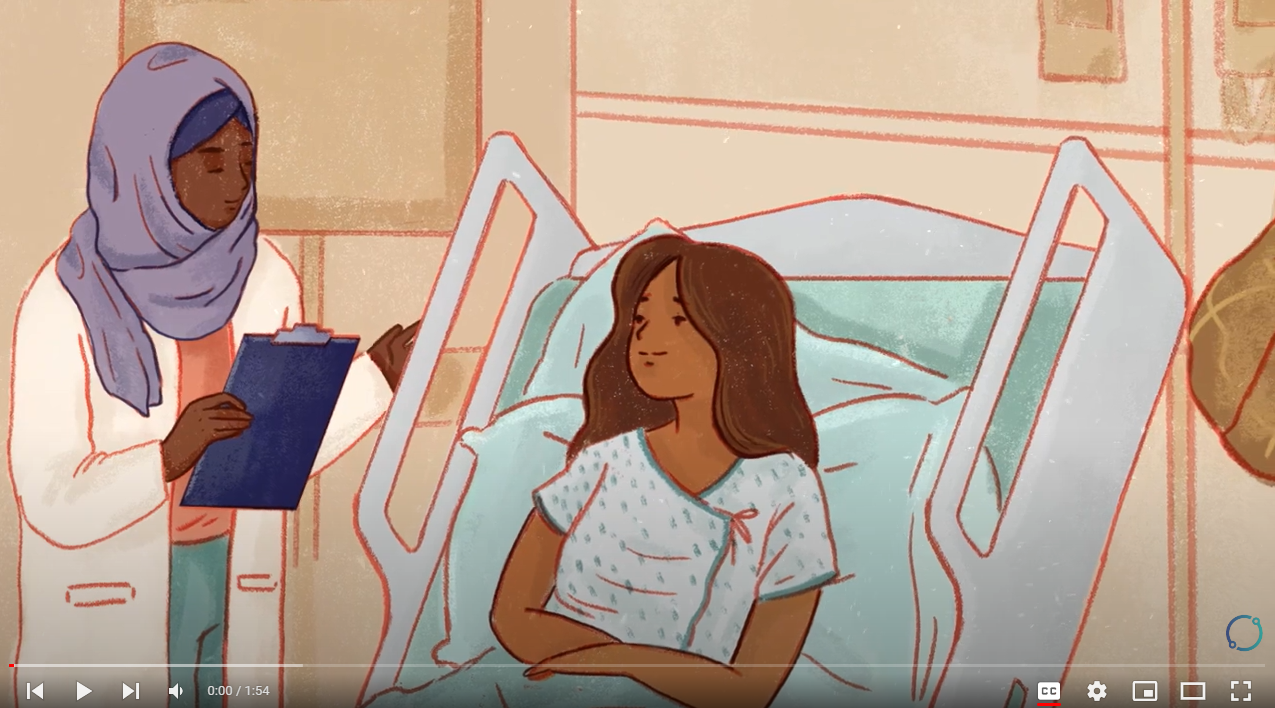 A Black doctor wearing a headscarf speaks to a patient in a labor room